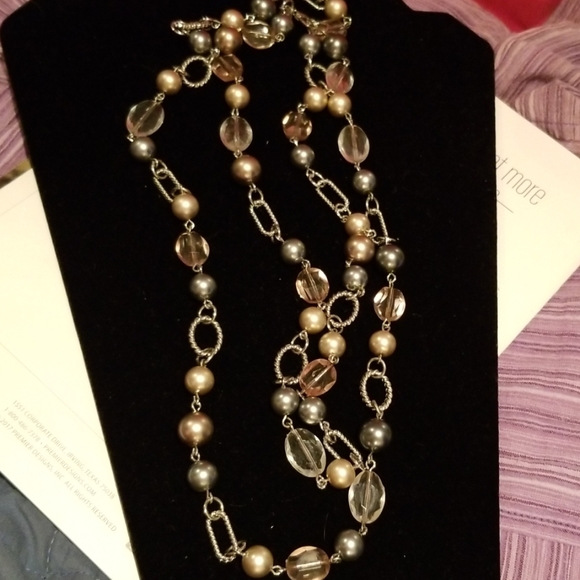 Necklace, silver and beads are gray and pink